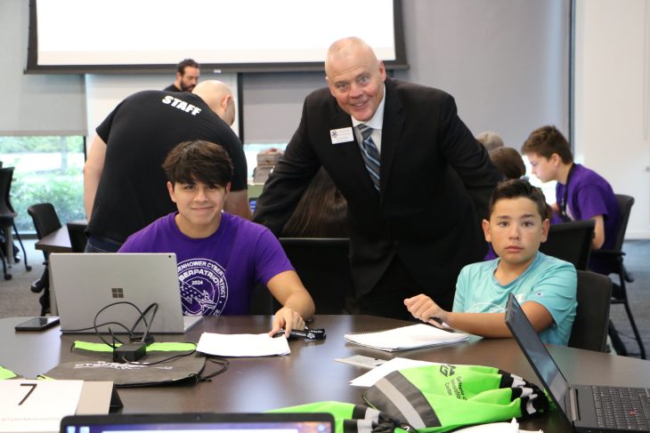 Tom Clark, Executive Director at the Alliance for Fort Gordon and students at Cyber Patriot