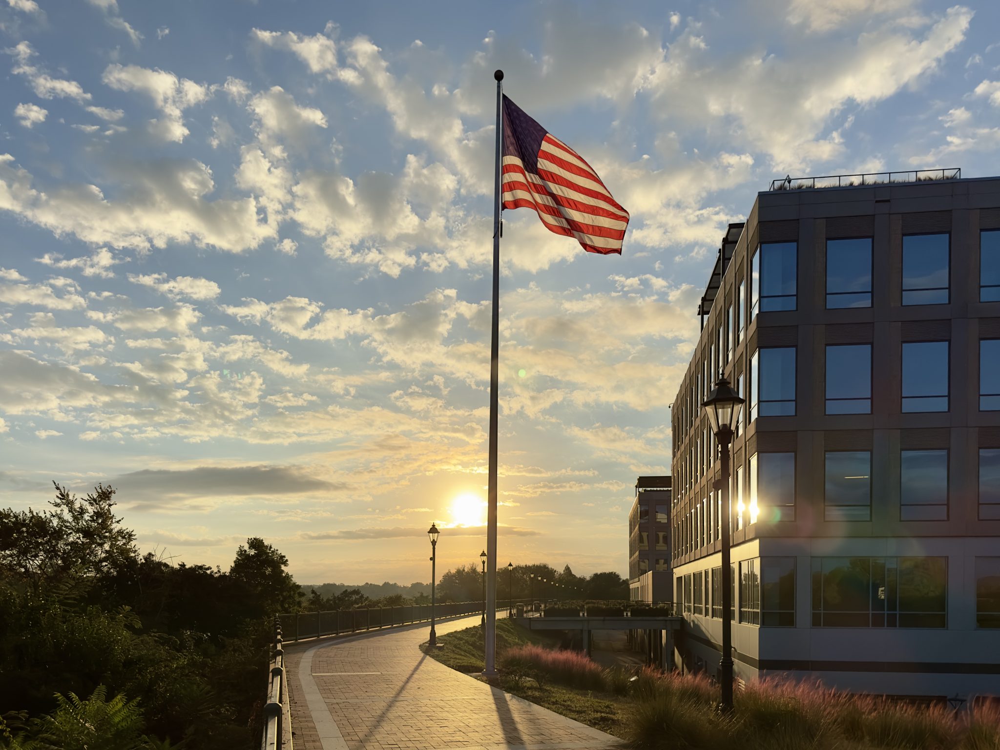 The American flag waving at sunset on the Augusta riverwalk at the Georgia Cyber Center