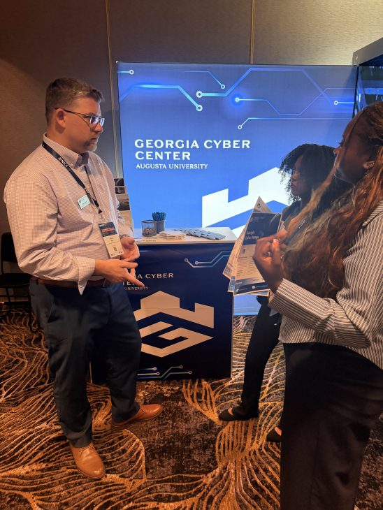 Georgia Cyber Staff speaking to others about the Georgia Cyber Center