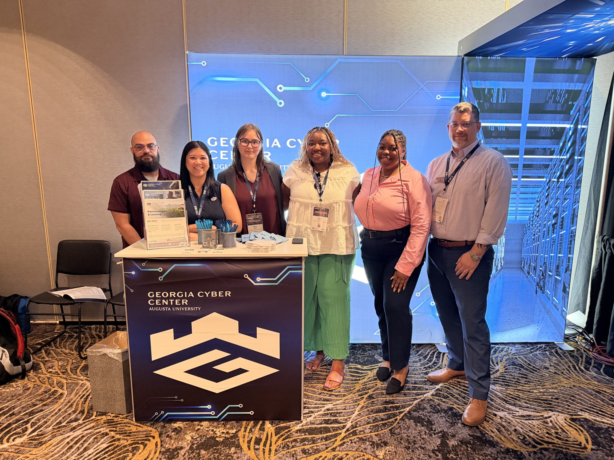 Group behind Georgia Cyber booth at Nice Conference