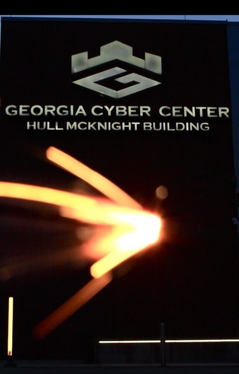 4th of July sparkler ablaze in front of Georgia Cyber Center at Augusta University signage