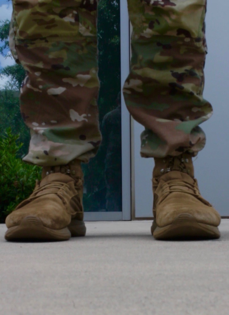Military member in uniform standing on Georgia Cyber Center campus with a focus on pants and boots 