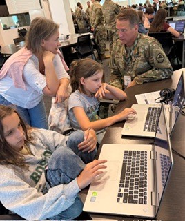 Middle and high school students working on computers during a Capture the Flag exercise by Parsons in the Georgia Cyber Center virtual world