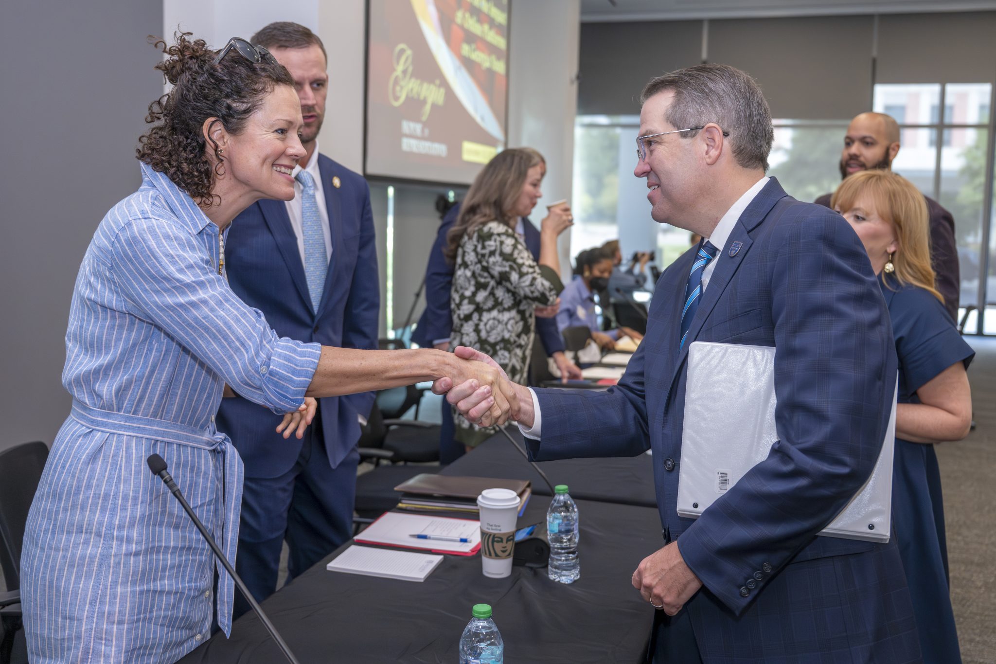 Augusta University President Russell Keen shaking hands with Georgia House Blue Ribbon Committee
