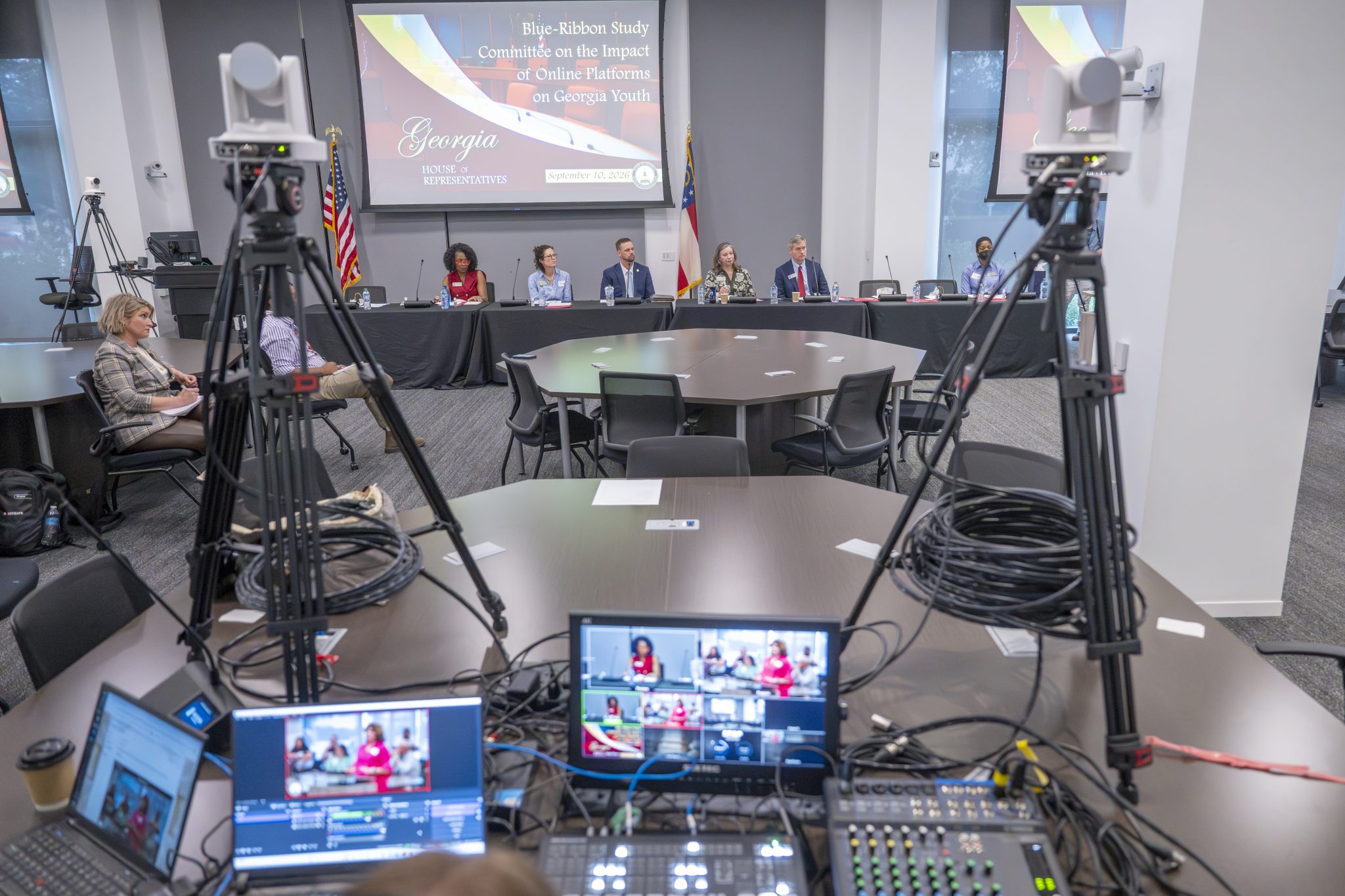 Committee on the Impact of Online Platforms seated behind 2 cameras in the Georgia Cyber Center virtual world