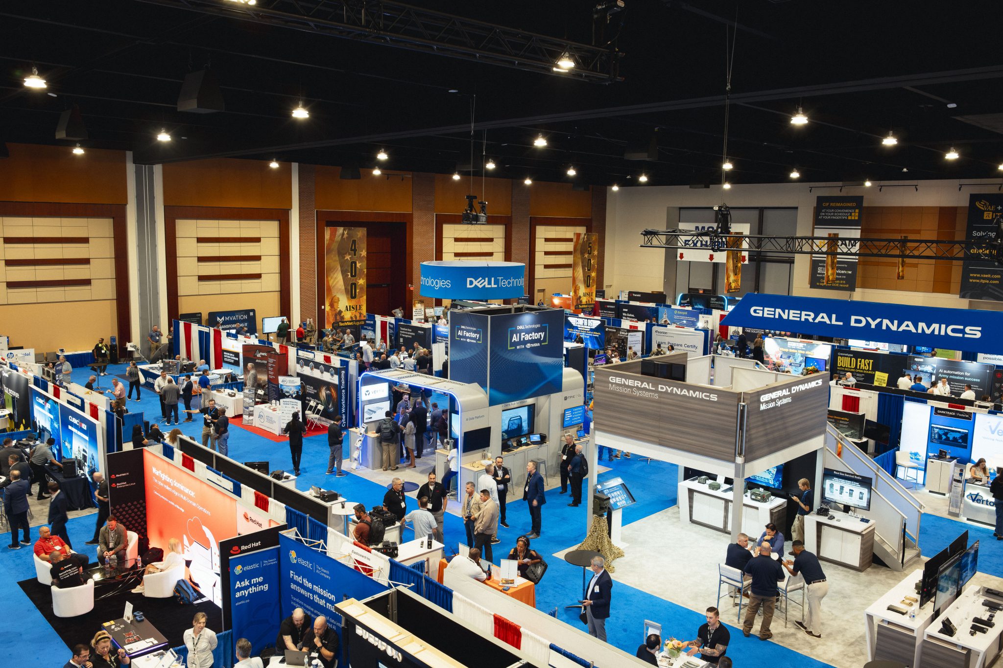High-angle wide view of the TechNet Augusta exhibition hall filled with vendor booths and attendee