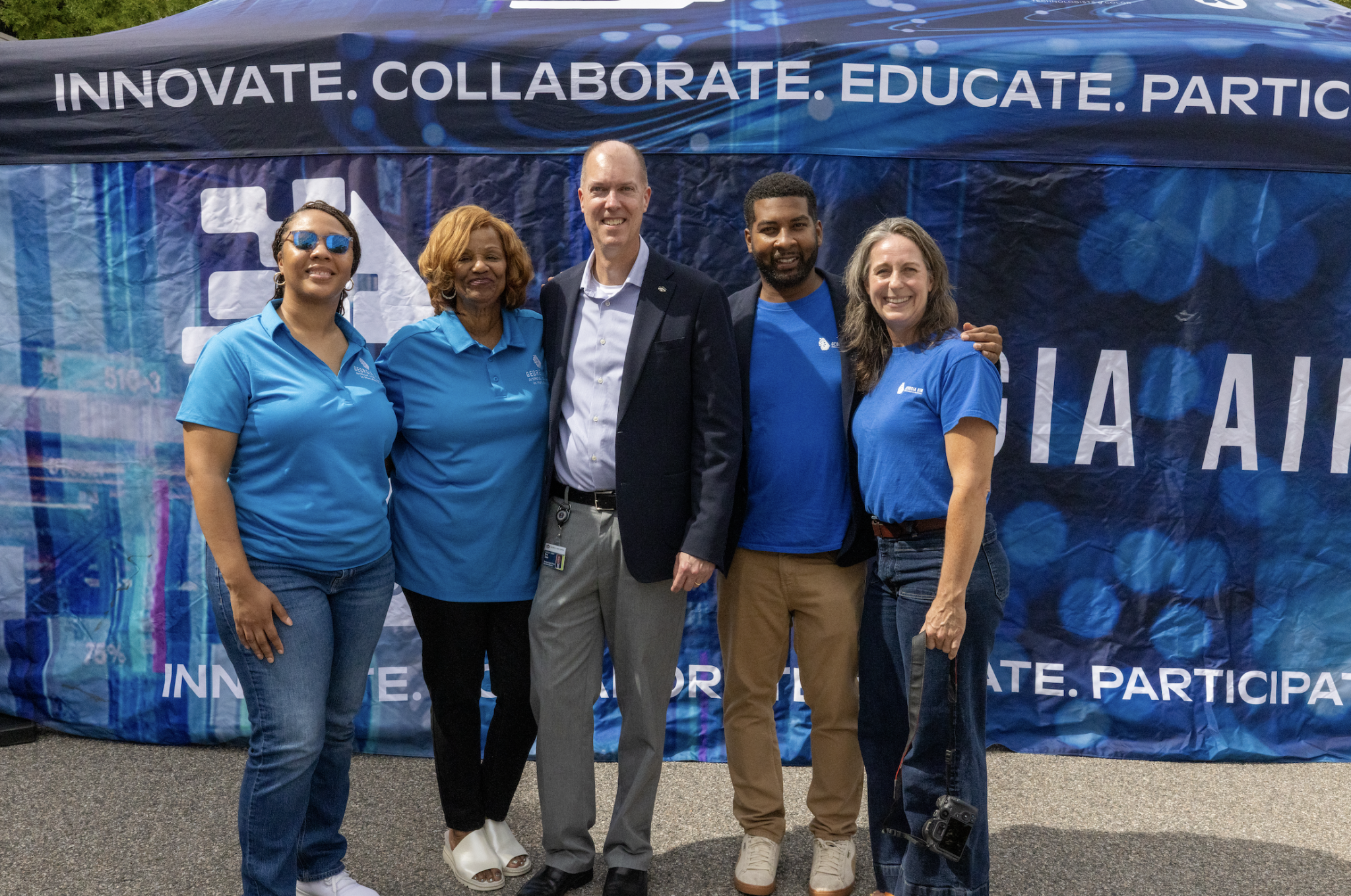 Eric Toler and Georgia AIM staff standing in front of RICE Georgia AIM Mobile Studio