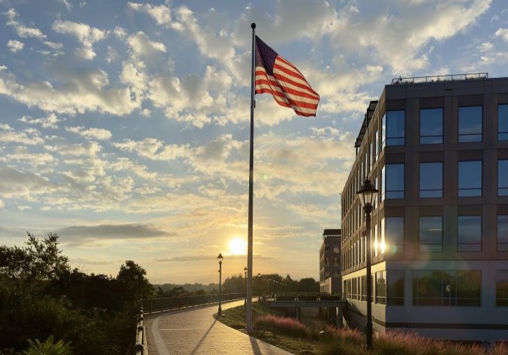 The American flag waving at sunset on the Augusta riverwalk at the Georgia Cyber Center