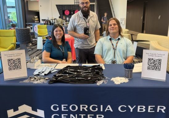 Georgia Cyber Center employees welcoming back Augusta University and Augusta Technical College students in the GCITC lobby