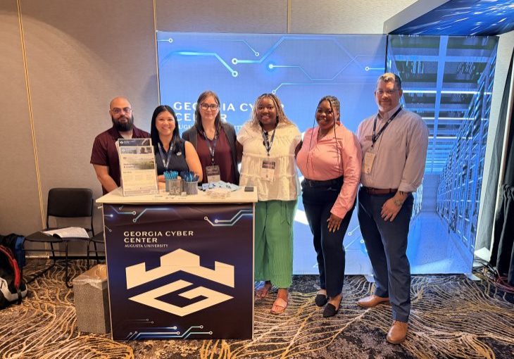Group behind Georgia Cyber booth at Nice Conference