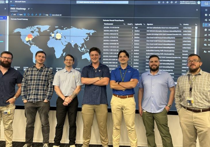 Student Cyber Analysts in front of Heat Map in SOC at Georgia Cyber Center